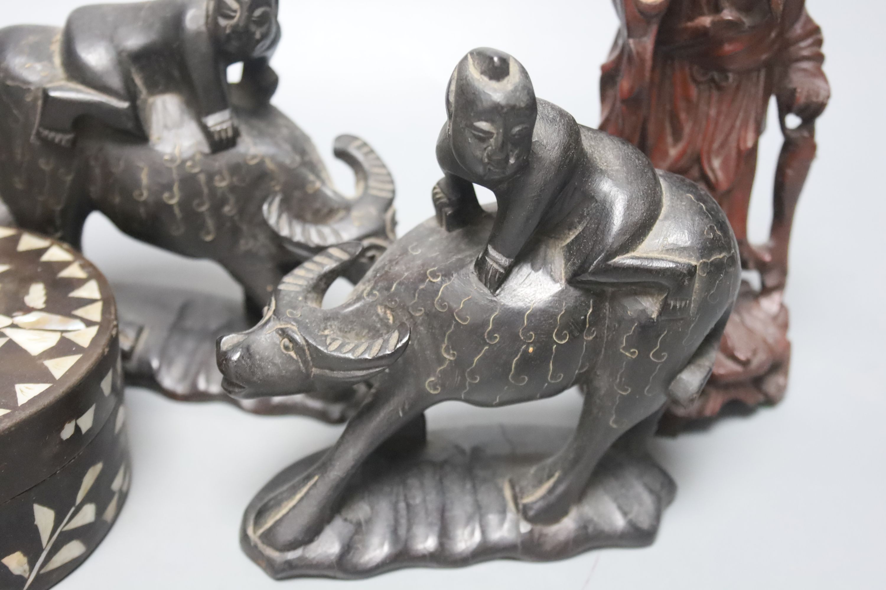 Four Chinese carved wood figures and a box, 18 cms high.